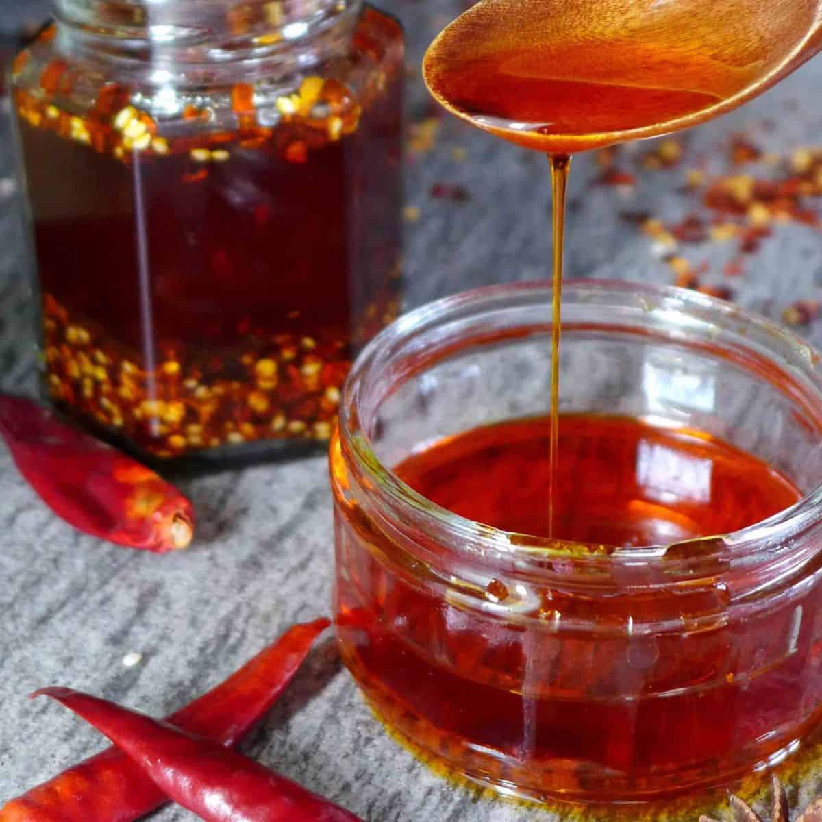 spoon pouring chinese chilli oil.