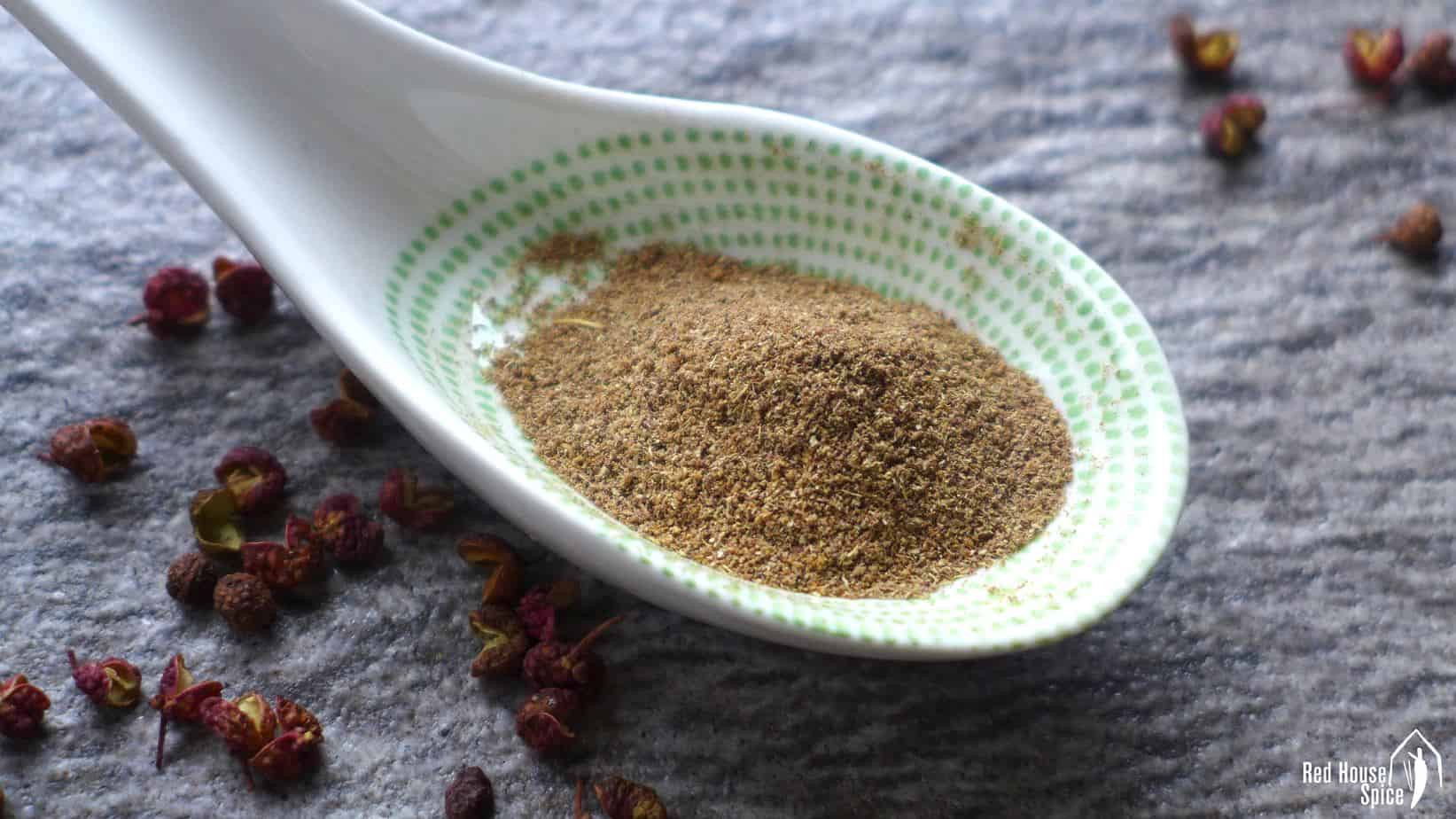 Freshly ground Sichuan pepper in a spoon.
