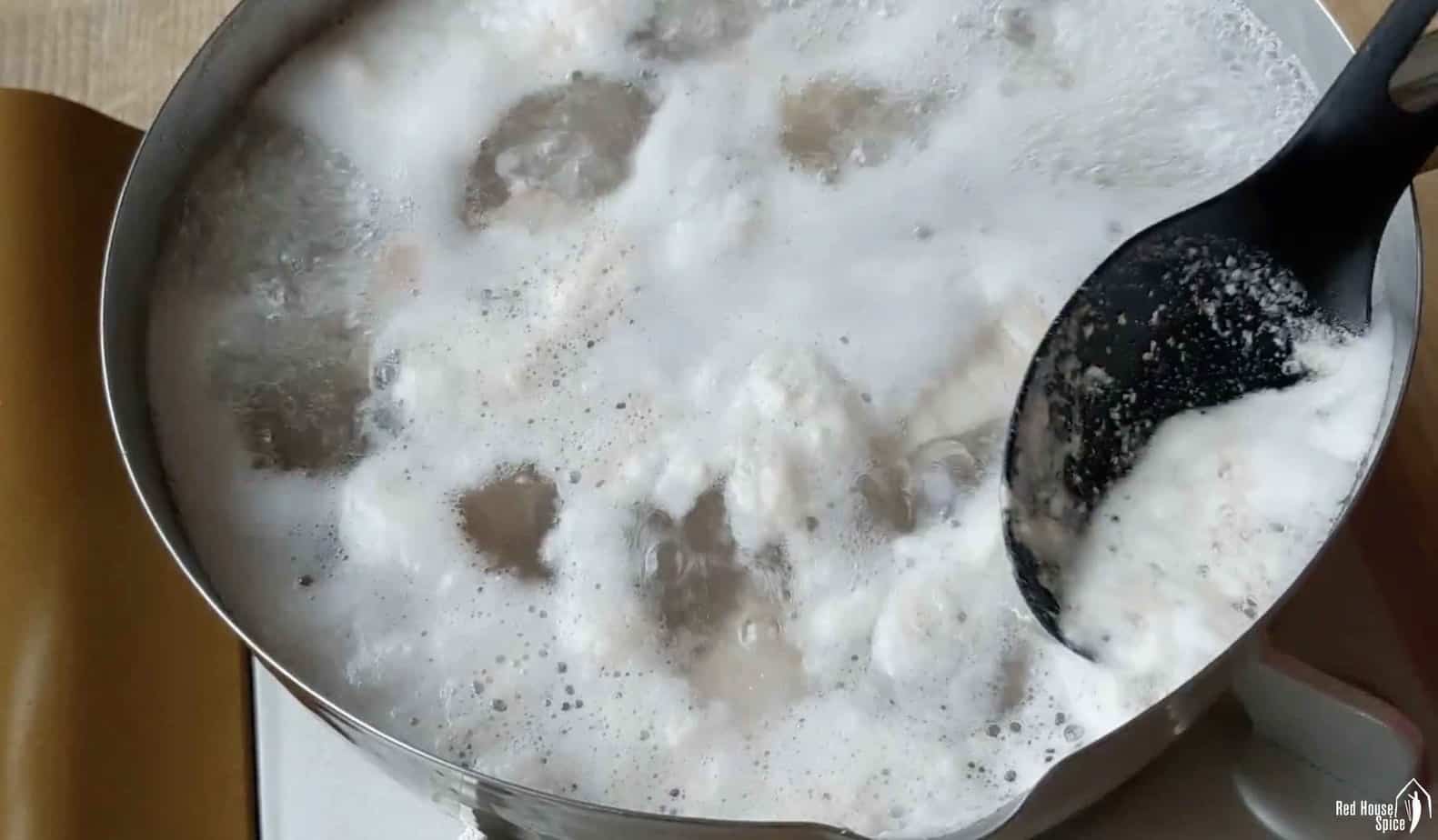 removing froth with a spoon
