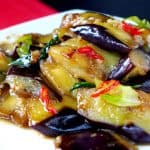 a plate of stir-fried eggplant with plum sauce