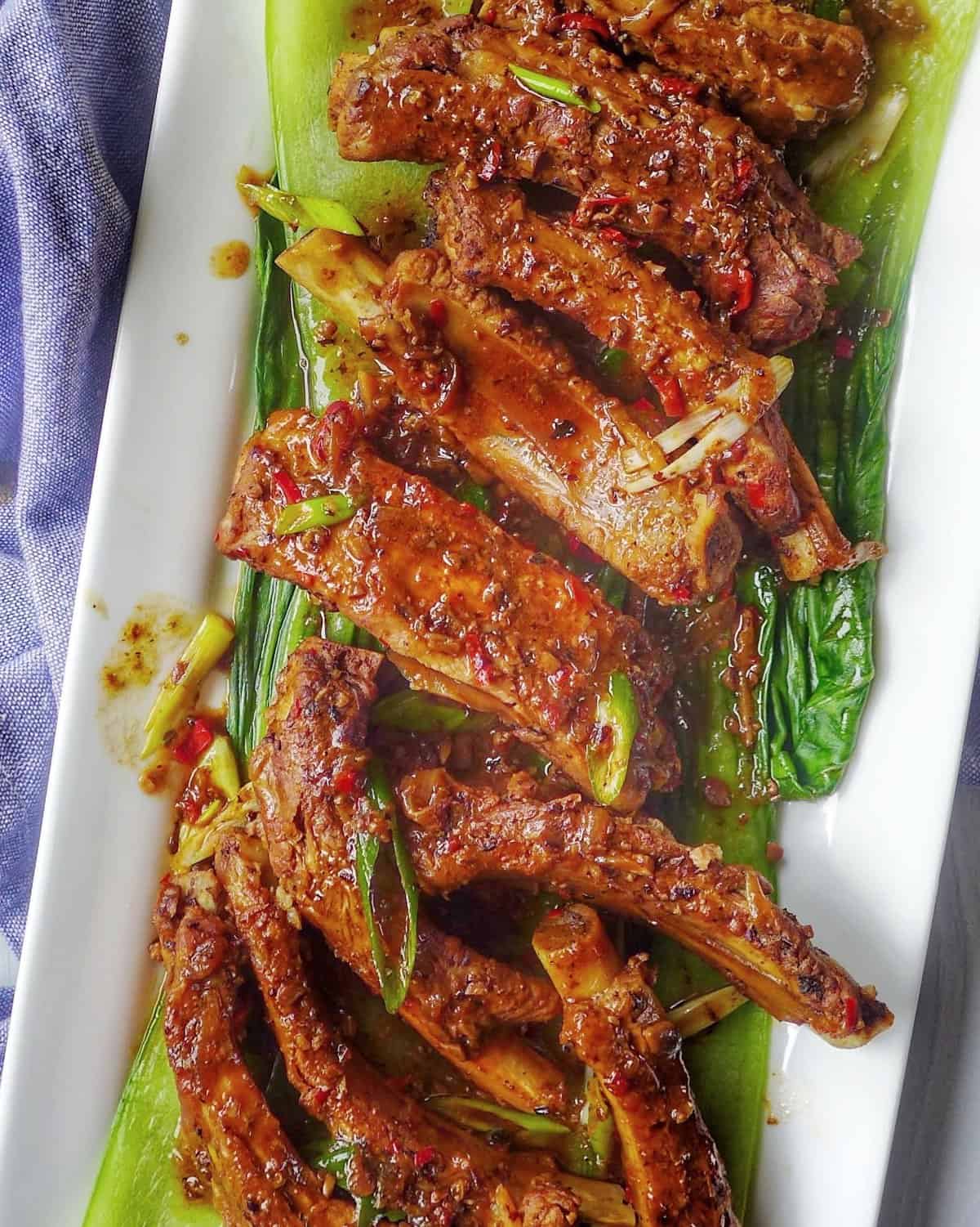braised pork ribs with black bean sauce over blanched bok choy