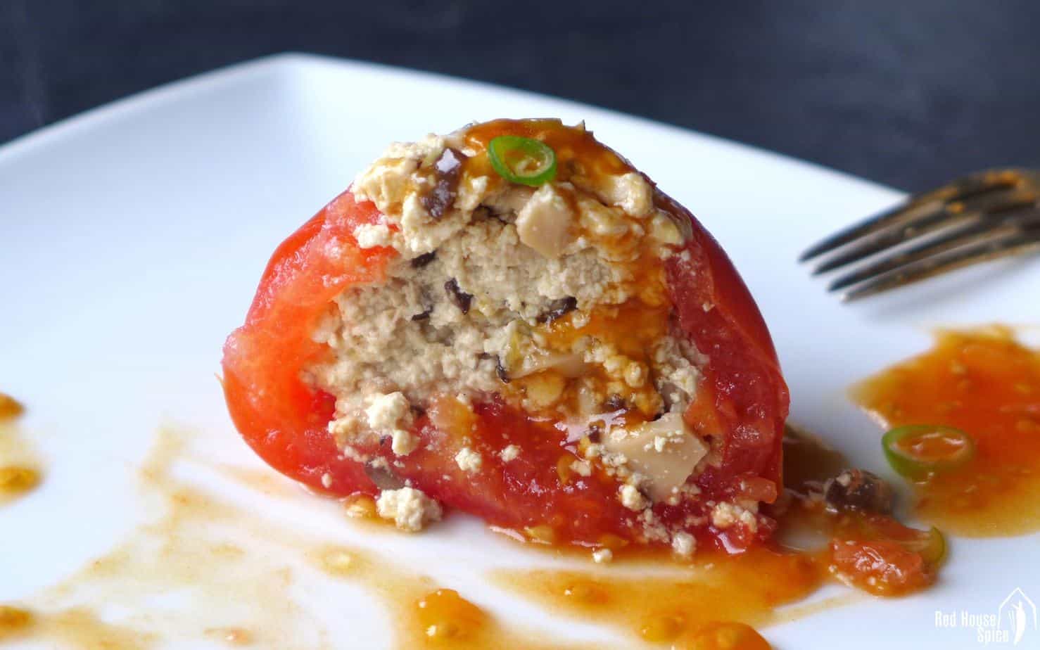 Juicy tomatoes are hollowed and steamed with well seasoned tofu crumbs, then served with a sweet and sour sauce made from the pulp of the tomatoes.