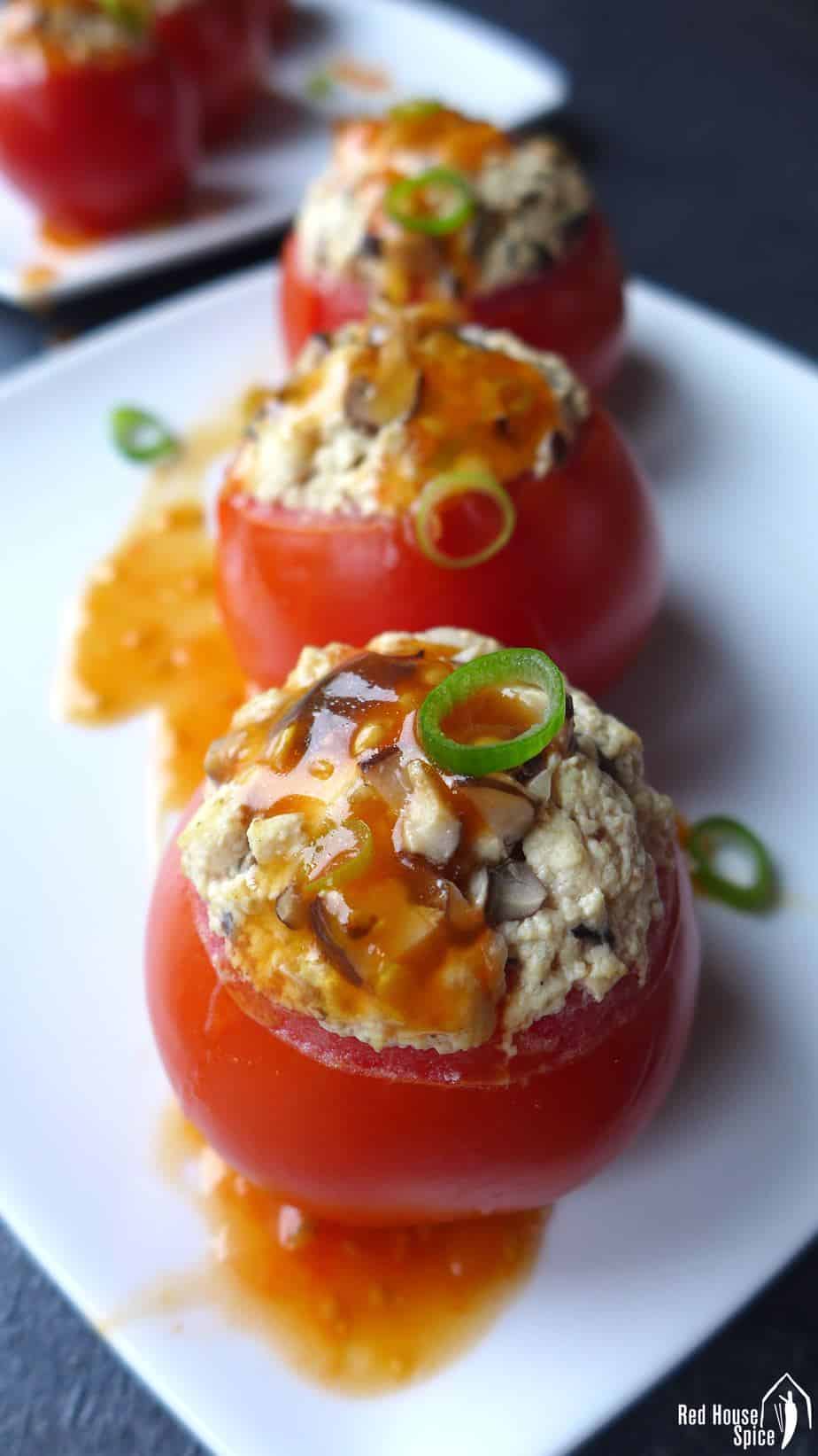 Juicy tomatoes are hollowed and steamed with well seasoned tofu crumbs. These tofu-stuffed tomatoes are then served with a scrumptious sweet and sour sauce.
