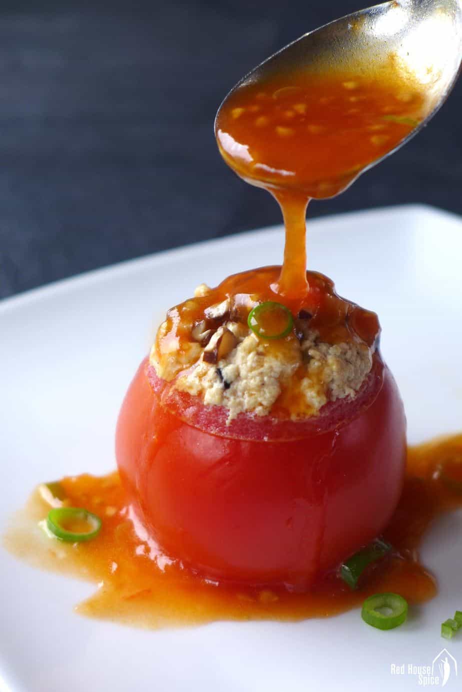 Juicy tomatoes are hollowed and steamed with well seasoned tofu crumbs. These tofu-stuffed tomatoes are then served with a scrumptious sweet and sour sauce.