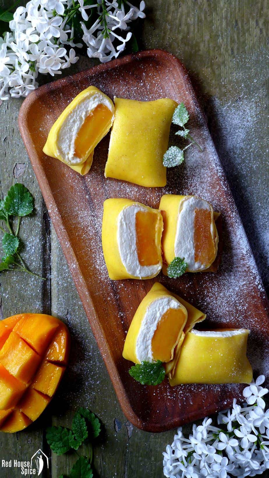 Fresh mango chunks topped with fluffy whipped cream, then wrapped with thin, moist and elastic crepes, these pillow-shaped mango pancakes are to die for.