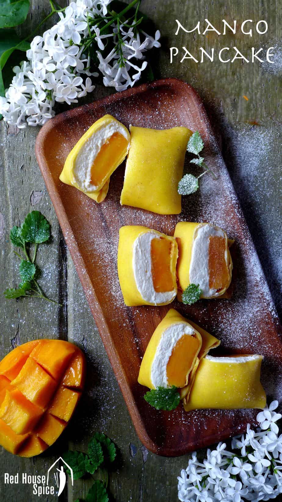 Fresh mango chunk topped with fluffy whipped cream, then wrapped with a thin, moist and elastic crepe, pillow-shaped mango pancake is a dessert to die for.