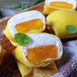 Hong Kong style mango pancakes filled with mango pieces and whipped cream
