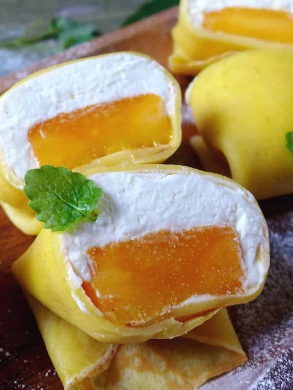 Hong Kong style mango pancakes filled with mango pieces and whipped cream