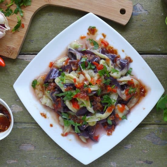 Steamed to a creamy, melt-in-your-mouth texture, then seasoned with a pungent chilli-garlic dressing, this Chinese aubergine salad is simple yet delectable.