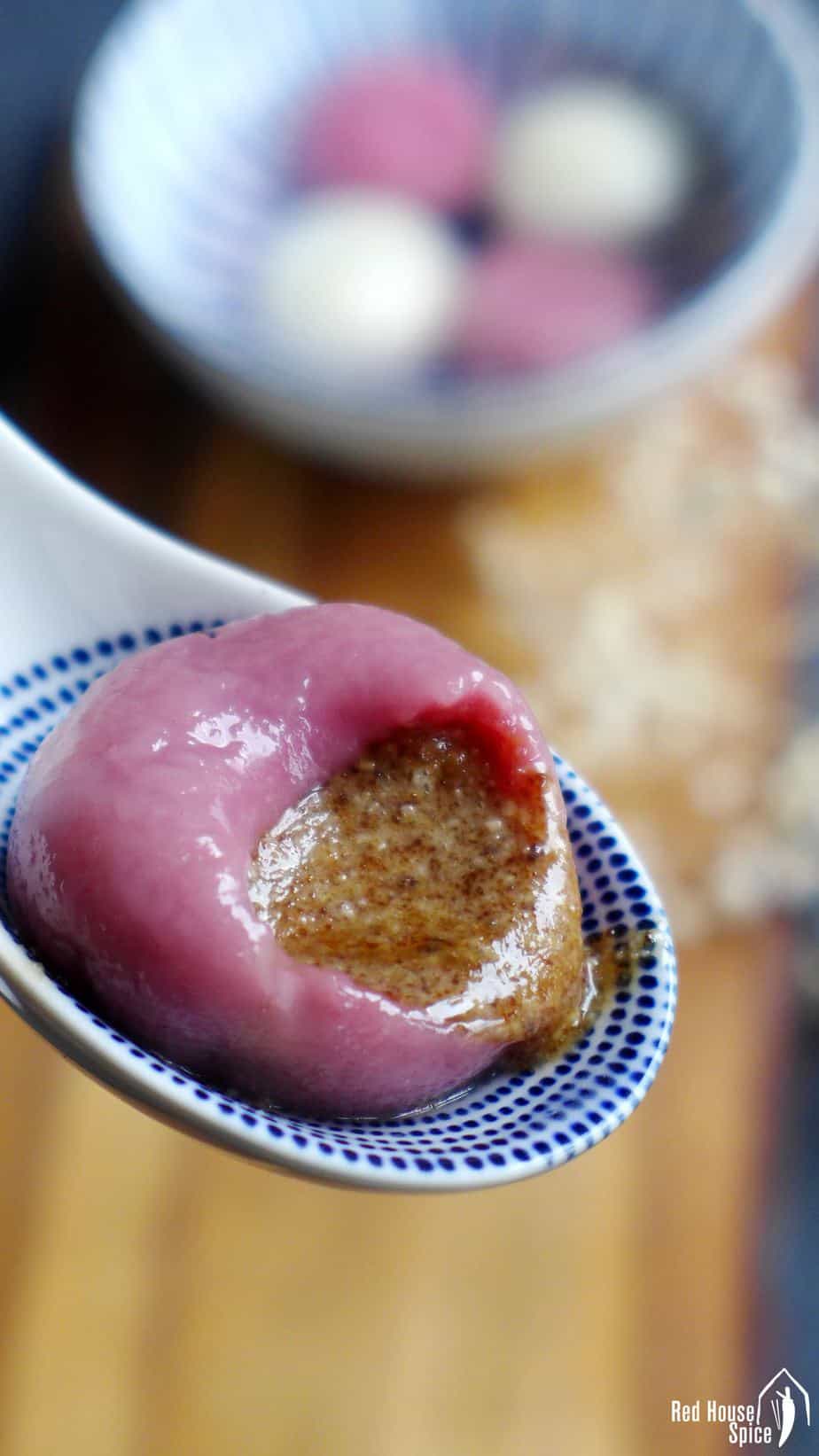 A pink Tang Yuan filled with peanut paste