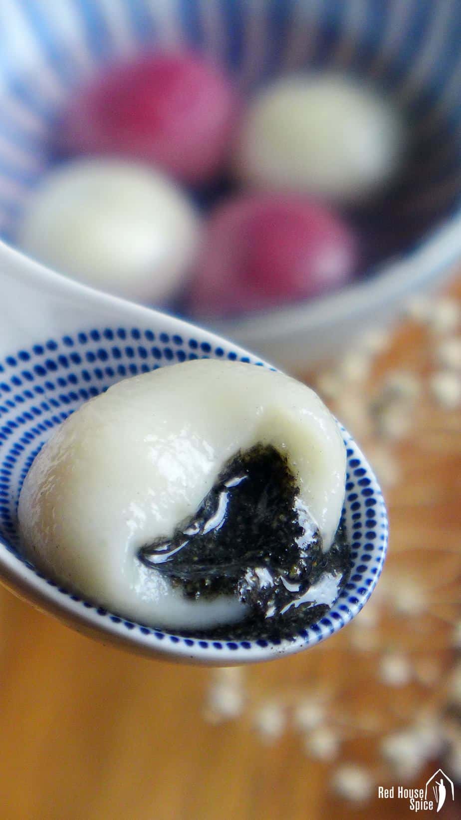 One half eaten Tang Yuan filled with black sesame paste.