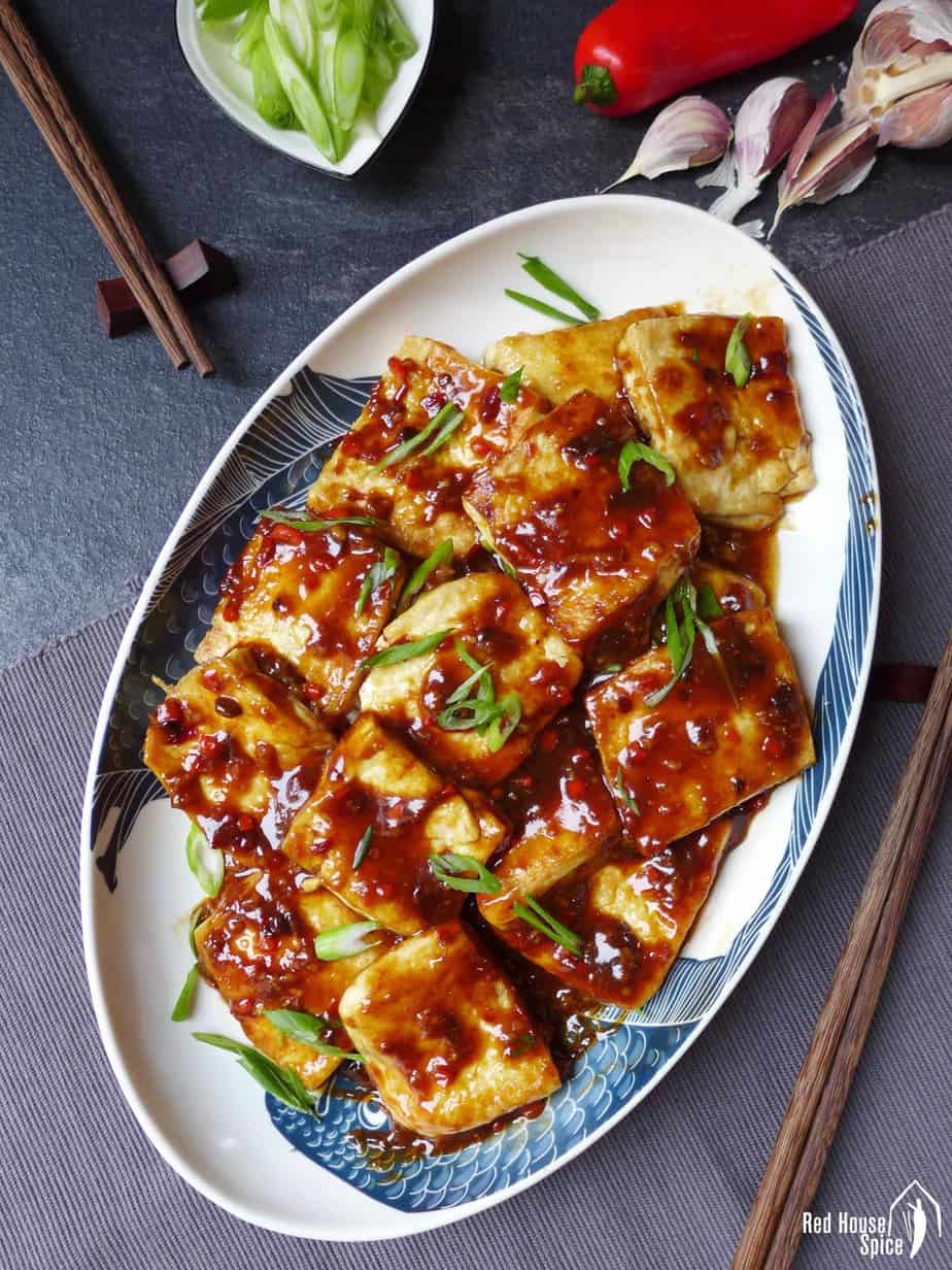 A plate of tofu coated with garlic sauce