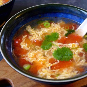 A bowl of tomato egg drop soup.