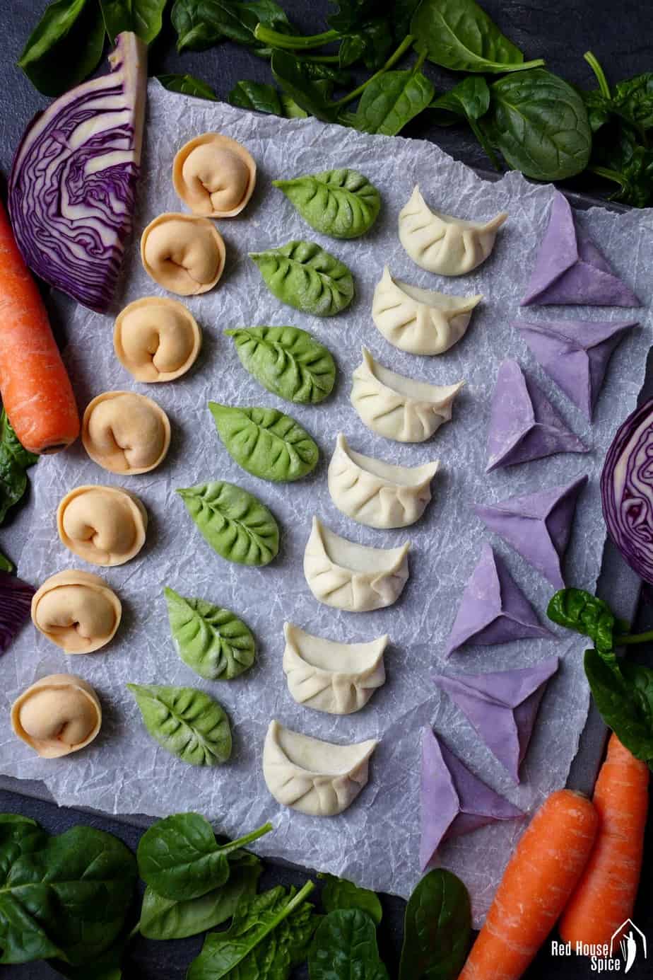 Chinese dumplings made in four colours and shapes for Chinese New Year.