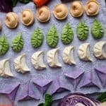 Lines of dumplings in white, green, orange and purple colour