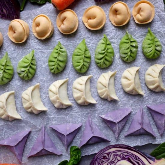 Lines of dumplings in white, green, orange and purple colour