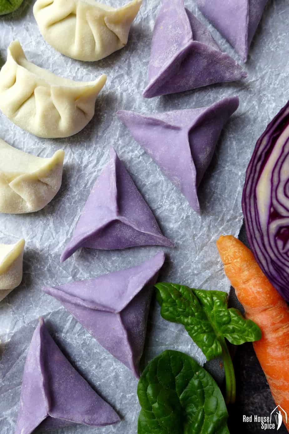 Chinese dumplings in purple colour and triangle shape.