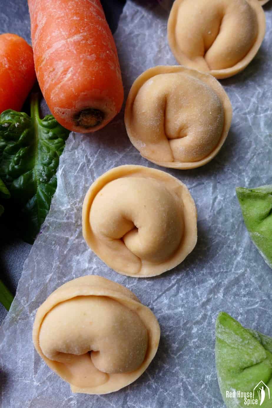 Chinese dumplings made in orange colour and ingot shape.