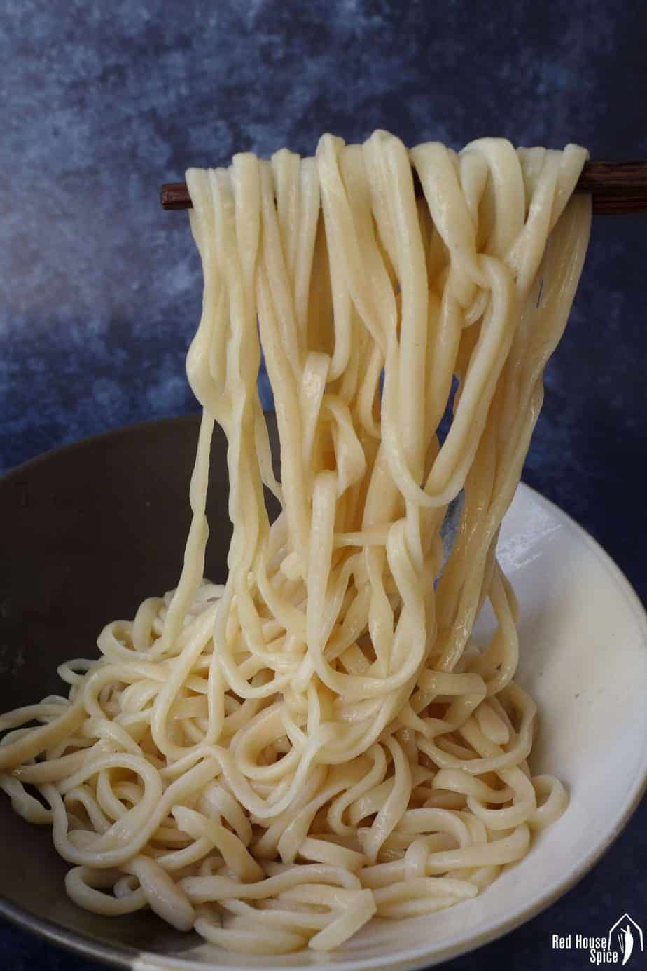 Hand-pulled noodles picked up by a pair of chopsticks