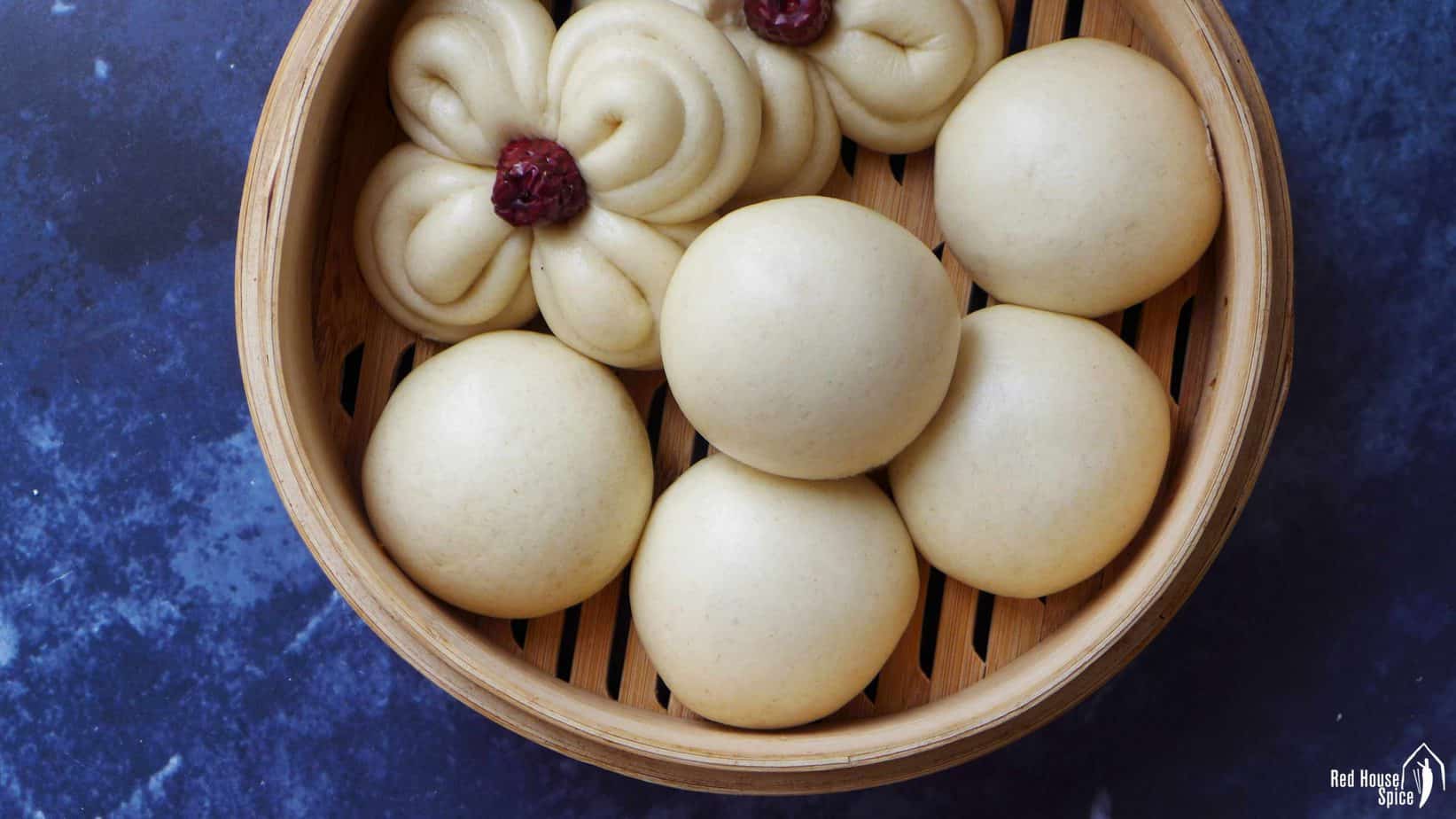 Chinese steamed buns in a bamboo basket.
