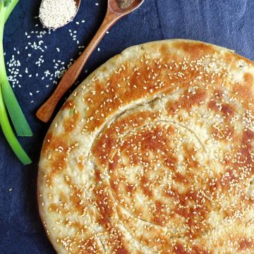 Spring onion flatbread topped with sesame seeds.
