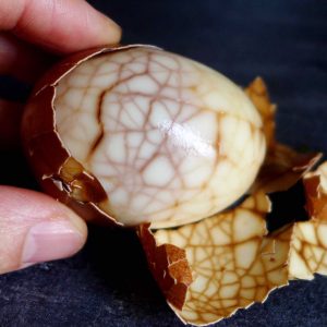 a chinese tea egg held by a hand