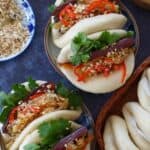 Assembled Gua Bao stuffed with pork belly slices.