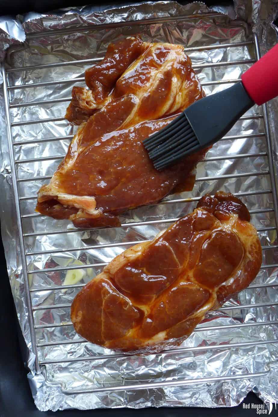 Brushing marinade on pork