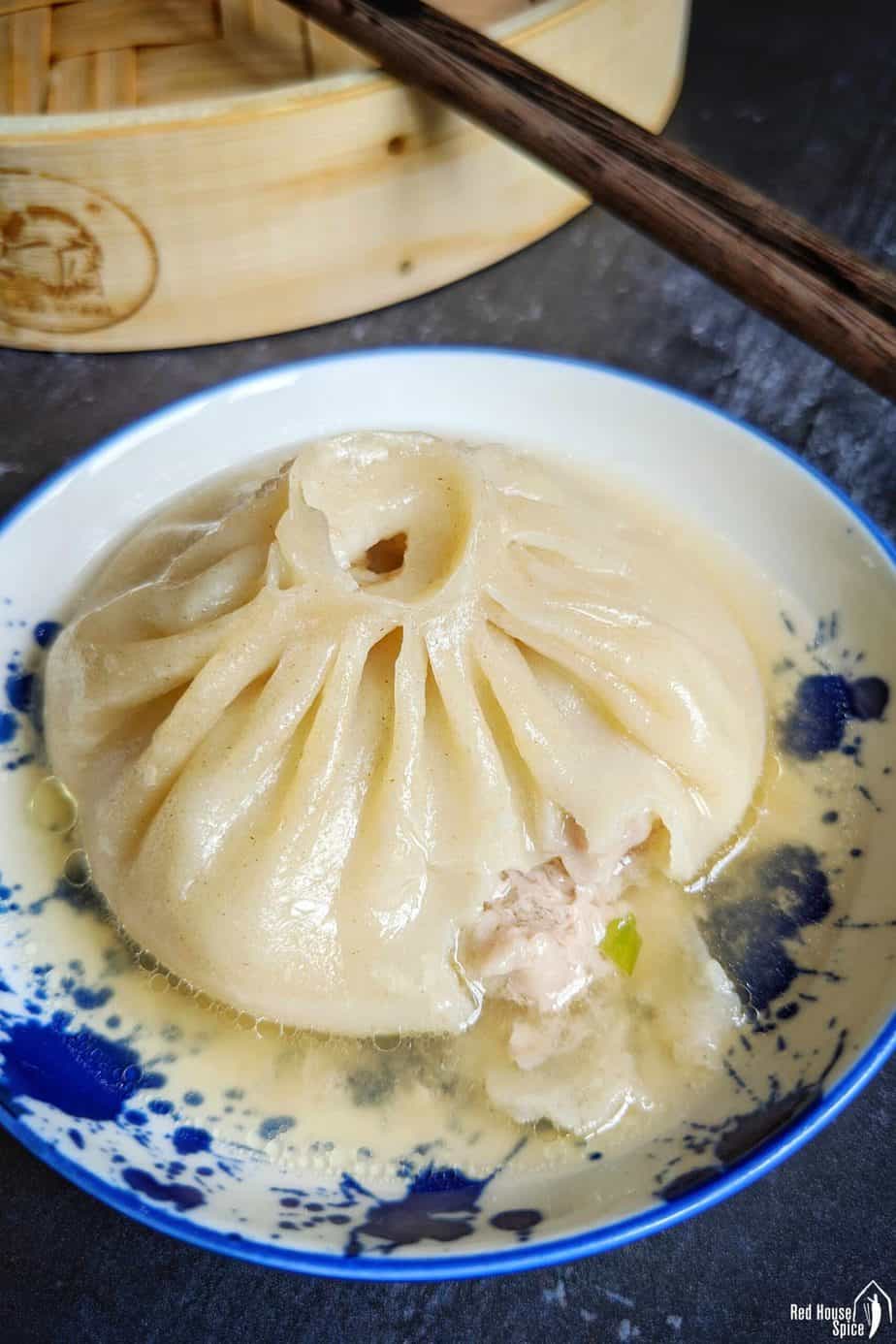 A soup dumpling showing the filling