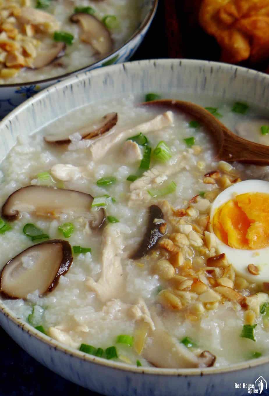 chicken and mushroom congee topped with boiled egg and peanuts