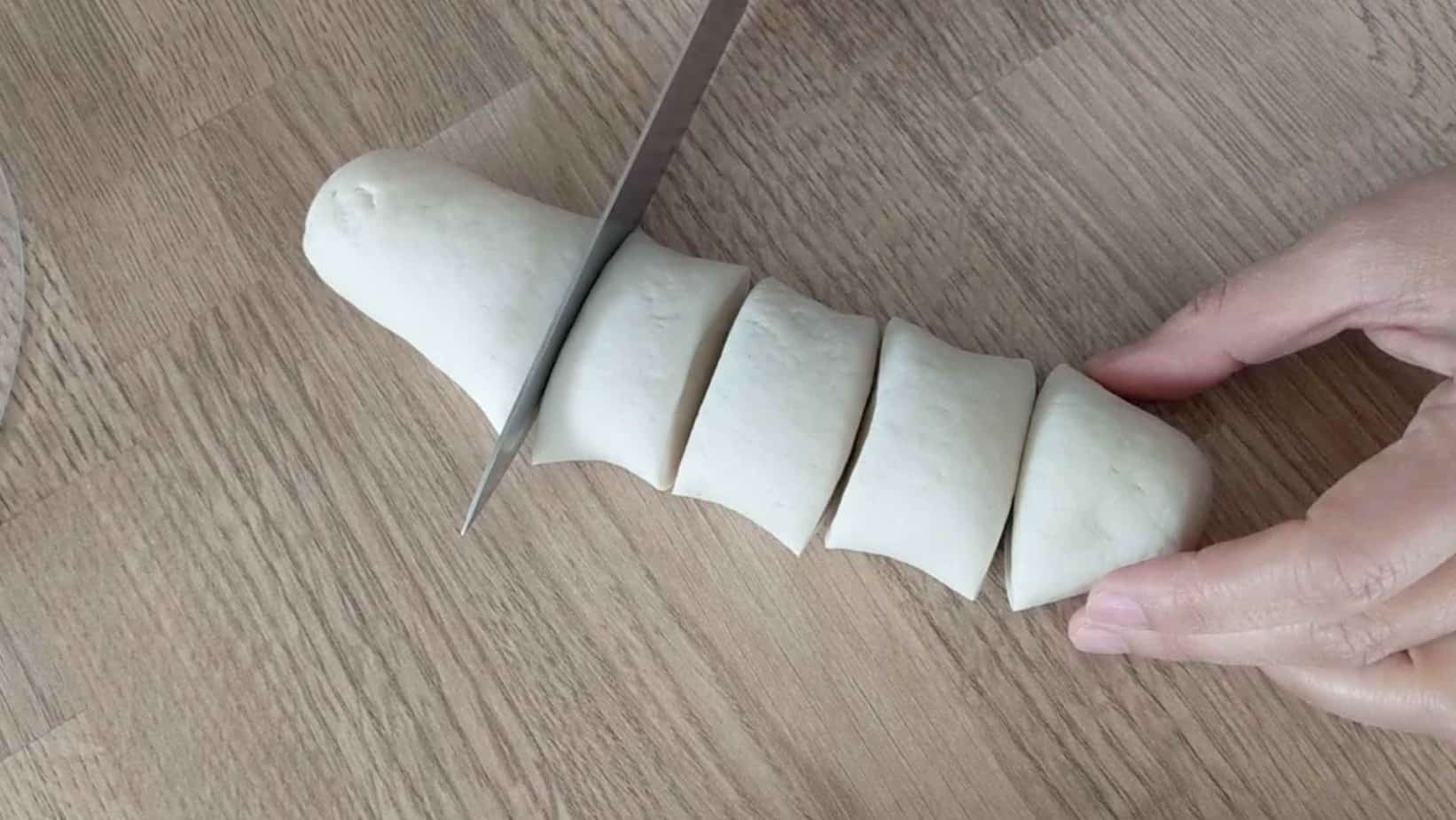 cutting a piece of dough