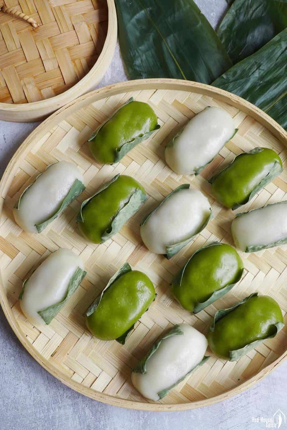 Green and white leaf-wrapped sticky rice cakes