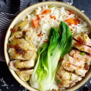 chicken over a bowl of rice