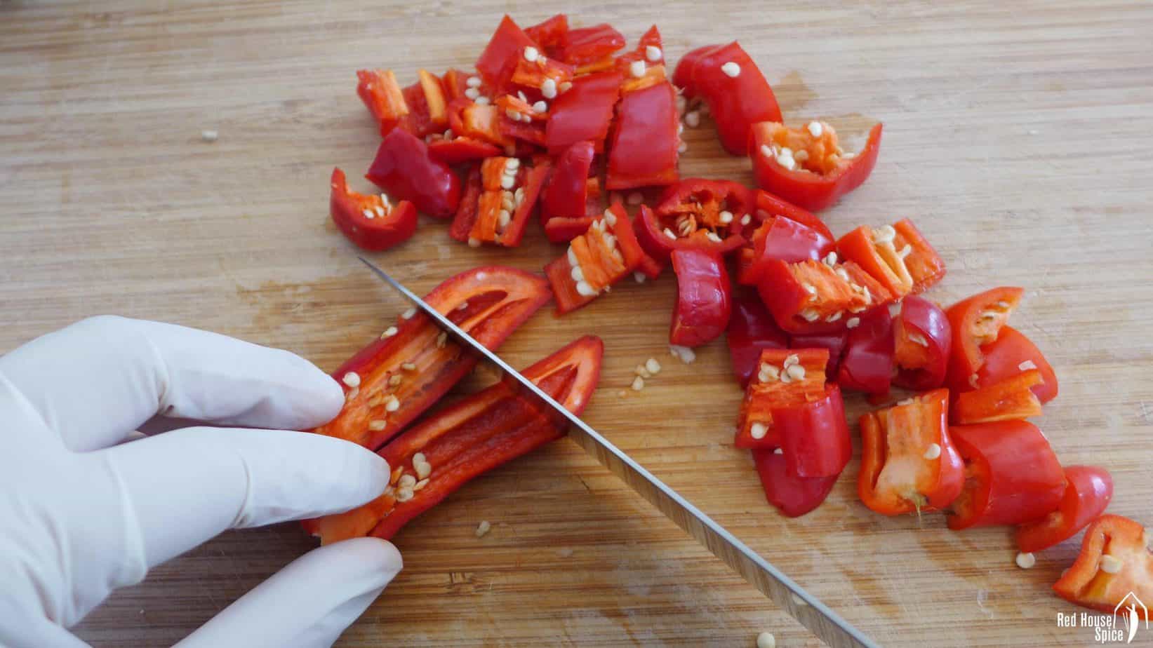 chopping chili peppers into chunks