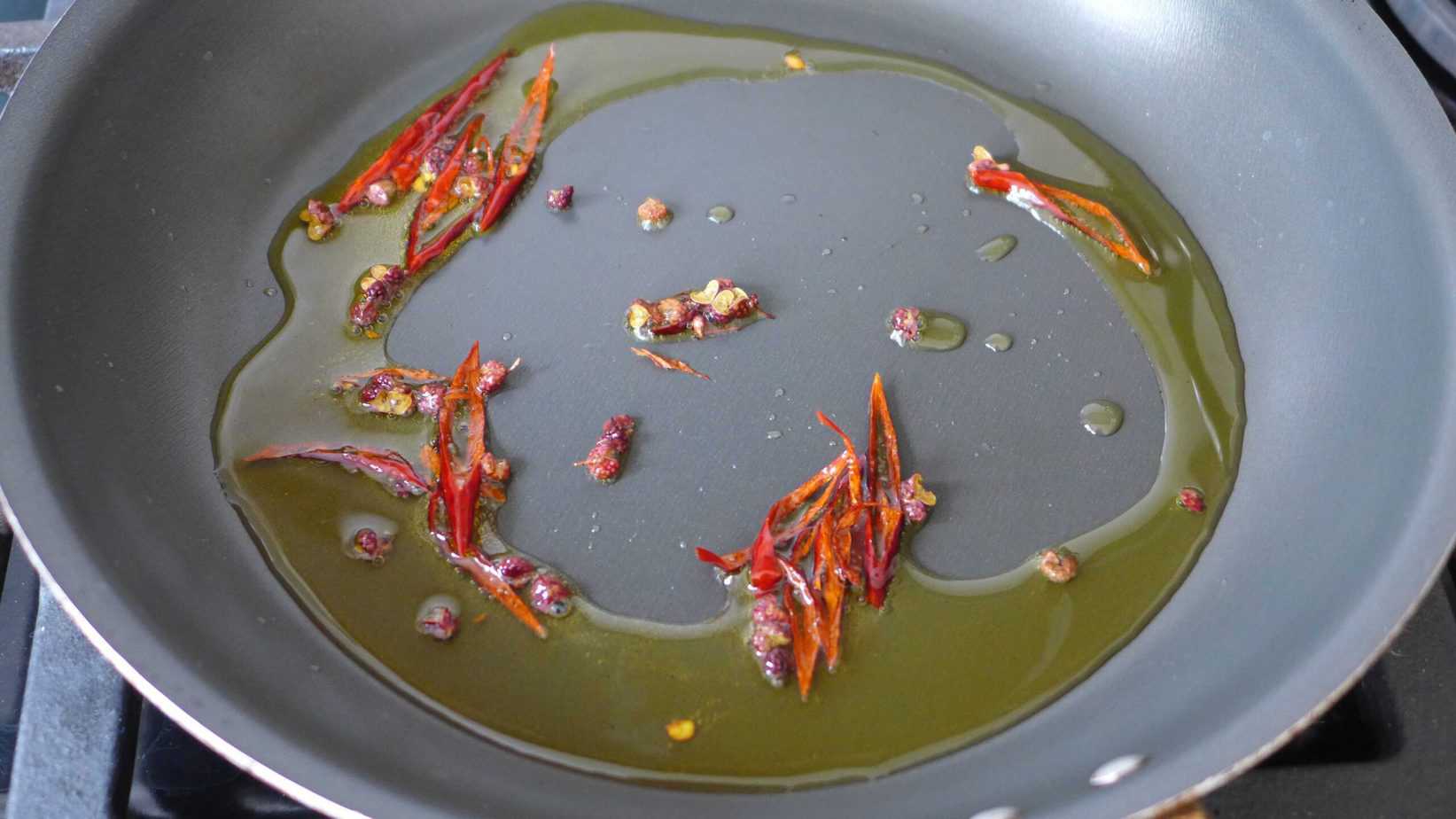 cooking dried chili and Sichuan pepper in oil