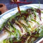 Pouring sauce over steamed fish