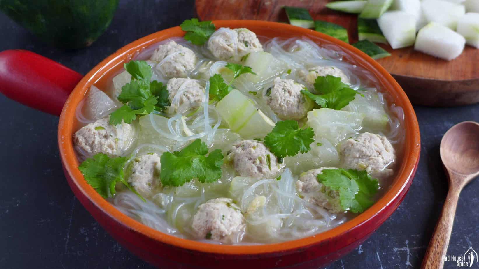 A pot of winter melon soup with meatballs and mung bean noodles