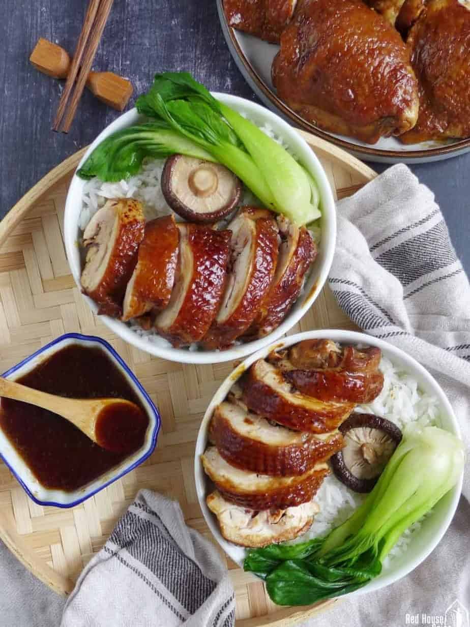 two bowls of soy sauce chicken over steamed rice.