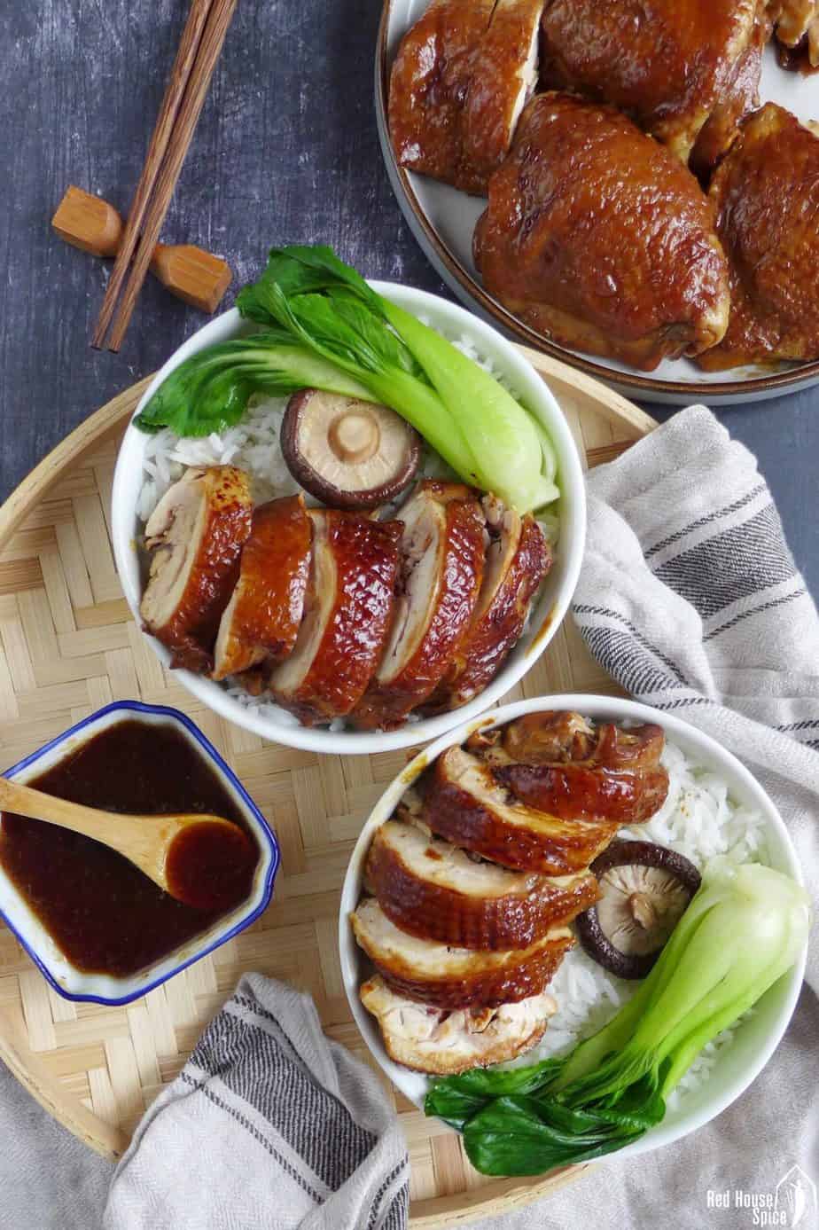 Soy sauce chicken served in rice bowls with vegetables
