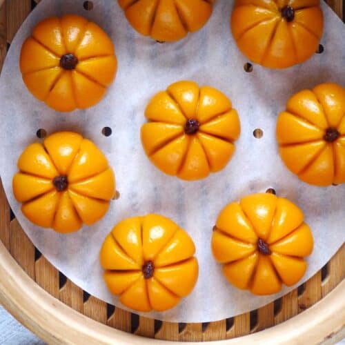 pumpkin shaped mochi cakes in a steamer.