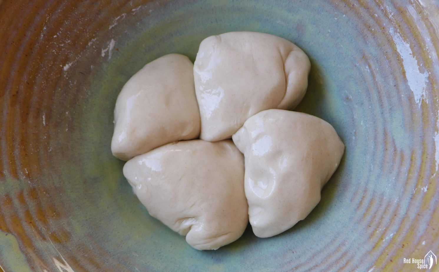four pieces of dough coated with oil