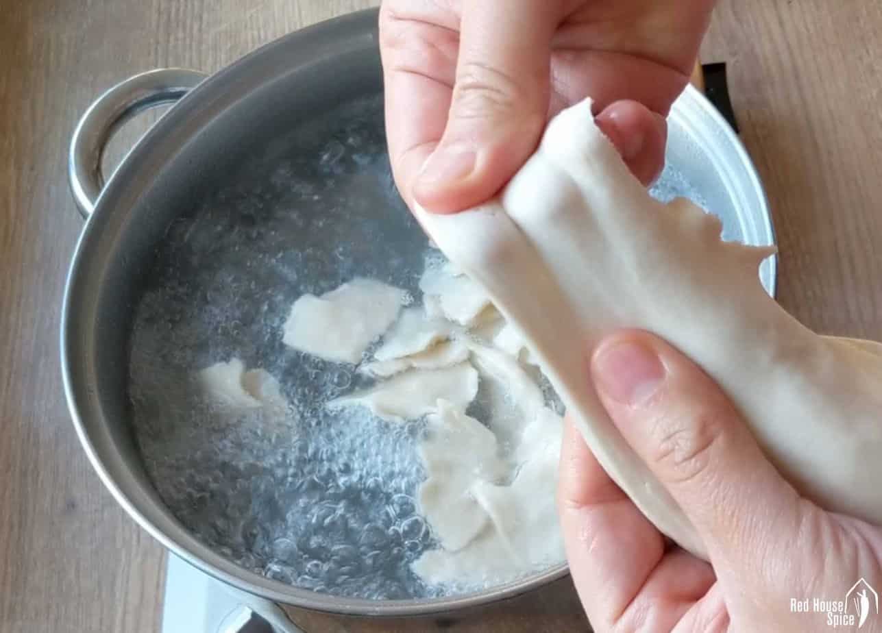 Tearing a piece of dough