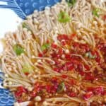 Steamed enoki mushroom topped with garlic and chili sauce