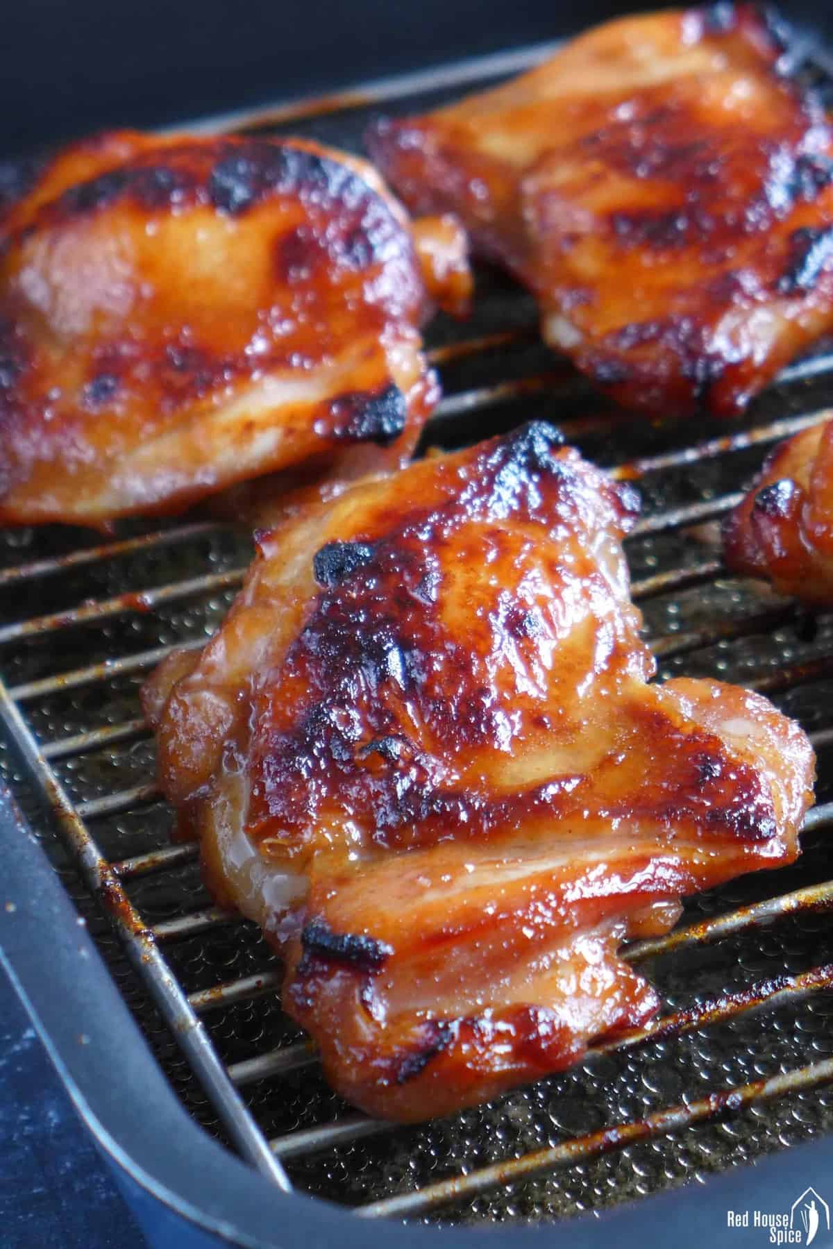 Char Siu chicken thighs on a wire rack