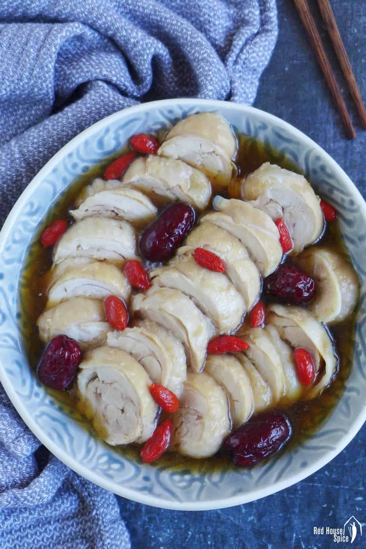 Sliced chicken in rice wine brine with red dates and goji berries