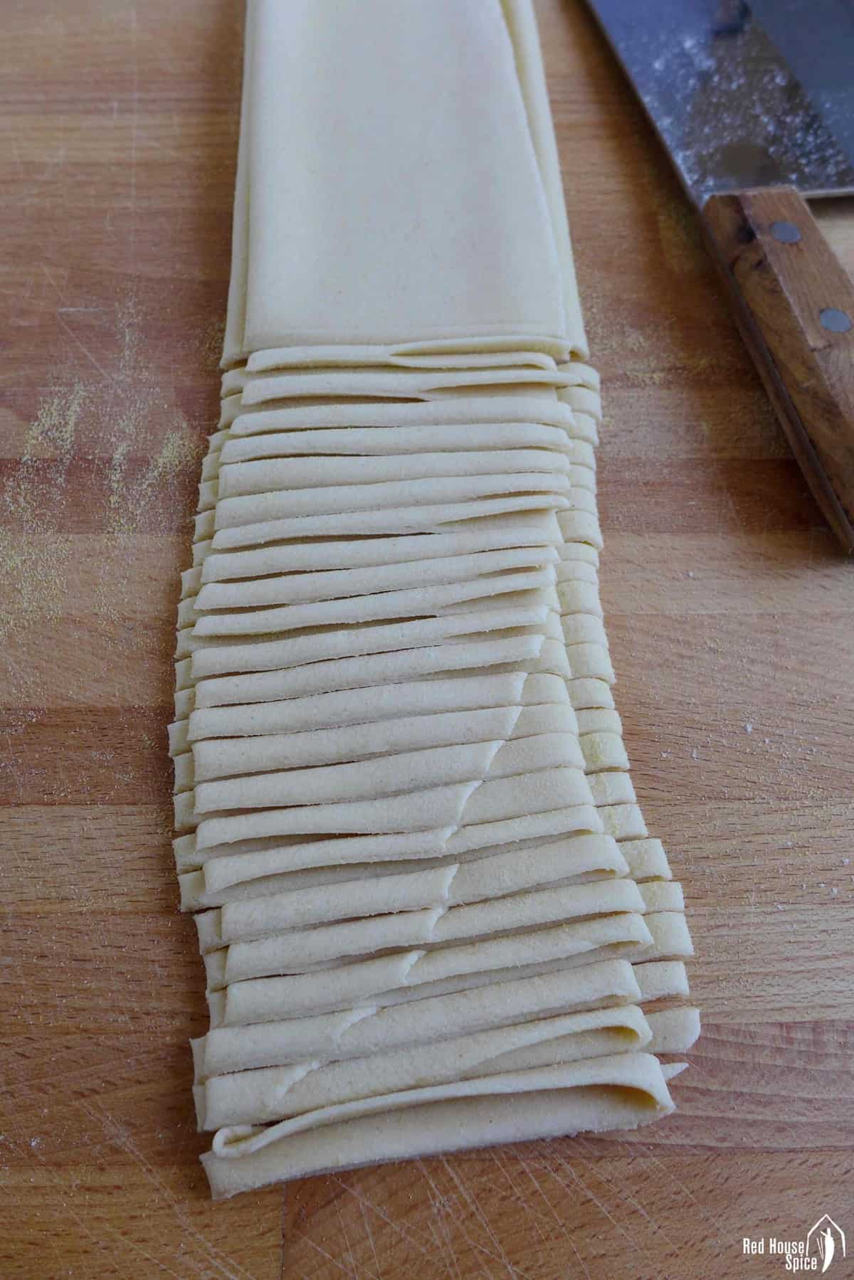 dough sheet folded and cut into strips