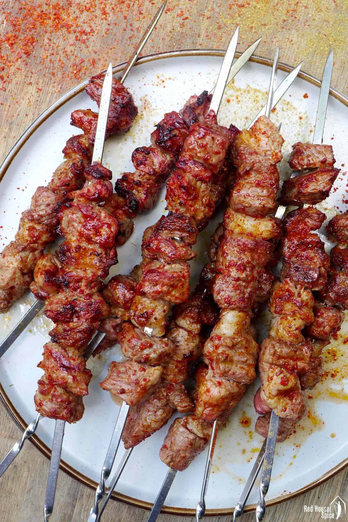cooked lamb skewers on a plate