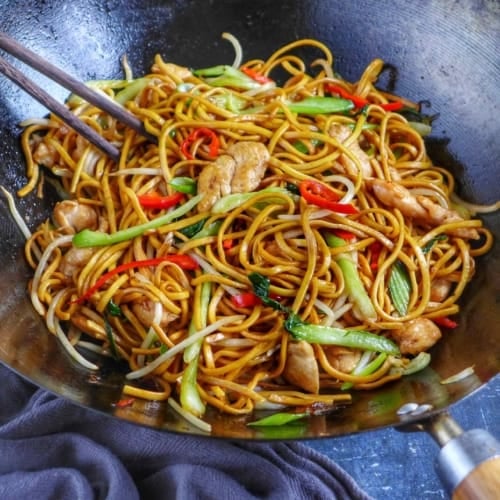 Chinese chicken chow mein in a wok