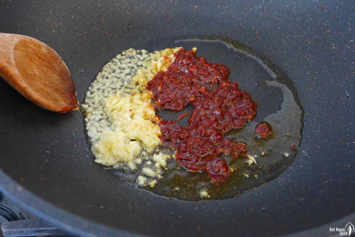 frying ginger, garlic and chili bean paste in oil