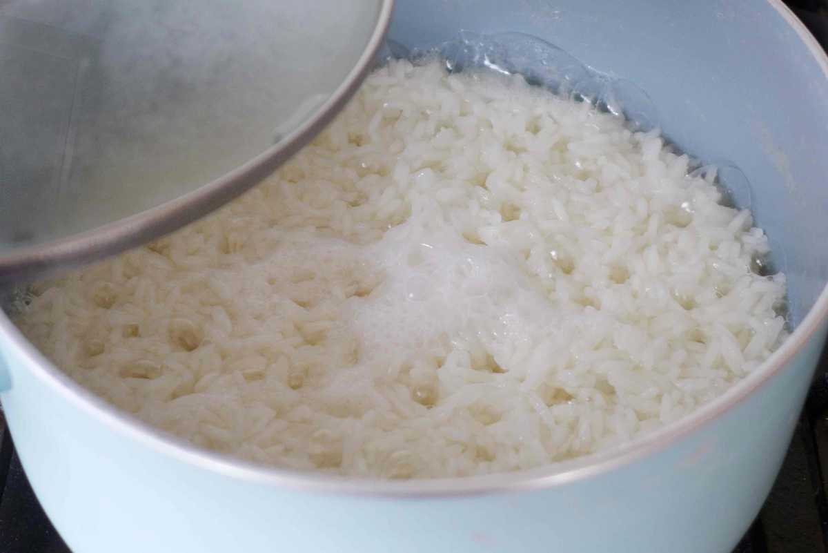 Half cooked rice in a saucepan